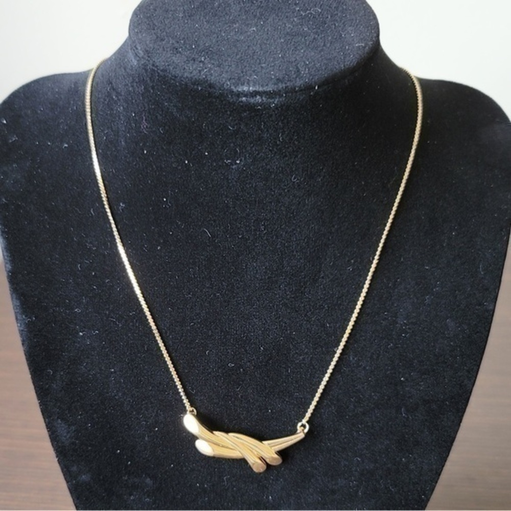 Golden necklace with modern pendant.